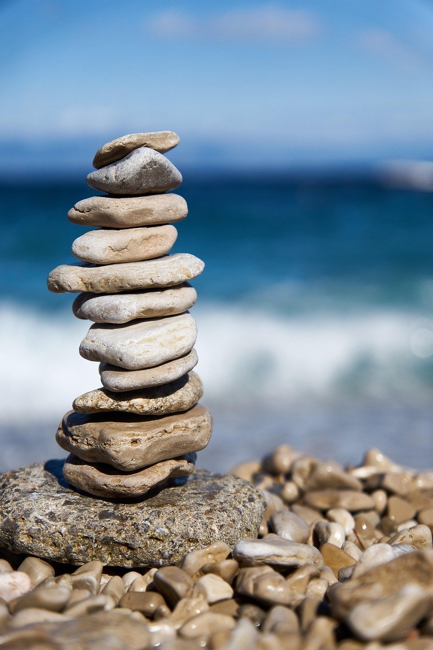 Services Peaceful beach with rocks stacked on each other